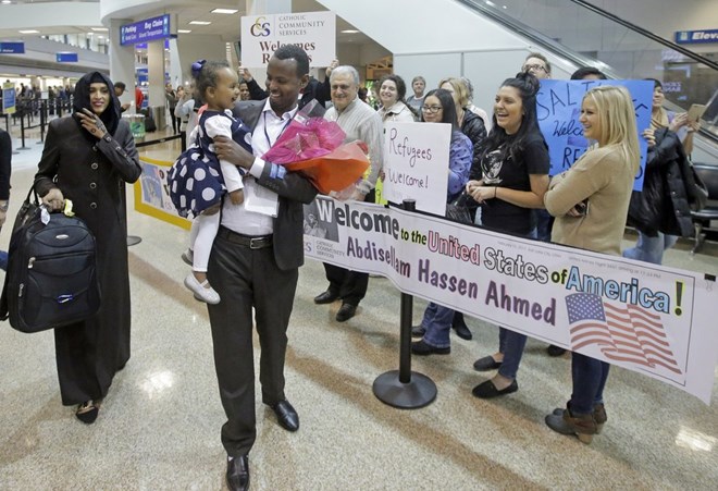 This Feb. 10, 2017, file photo, Abdisellam Hassen Ahmed, a Somali refugee who had been stuck in limbo after President Donald Trump temporarily banned refugee entries, walks with his wife Nimo Hashi, and his 2-year-old daughter, Taslim, who he met for the first time after arriving at Salt Lake City International Airport. President Trump appears to be ignoring a deadline to establish how many refugees will be allowed into the United States in 2021, raising uncertainty about the future of the 40-year-old resettlement program that has been dwindling under the administration. The 1980 Refugee Act requires presidents to issue their determination before Oct. 1, 2020, the start of the fiscal year. (Rick Bowmer, File/Associated Press)