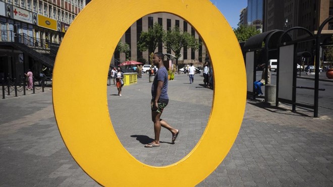 People walk through Ghandi Square in Johannesburg as restrictions to limit the spread of Covid-19 ease. South Africa's severe lockdown led to about 2 million job losses during the second quarter, statistics show. EPA