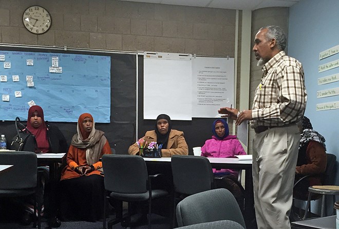 Mohamed Abass translates for newly immigrated Somali parents during the Waalidow Indhaha Furr session at Andersen United Community School on Dec. 2, 2015 in Minneapolis. Vanessa Nyarko