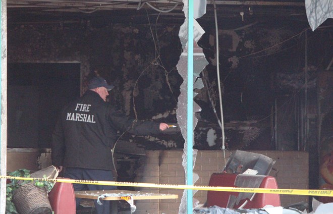 Investigators could be seen taking pictures of the site and digging through debris at Juba Coffee House, where a fire broke out in the early hours of Tuesday morning. Grand Forks Herald photo by Lori Weber Menke