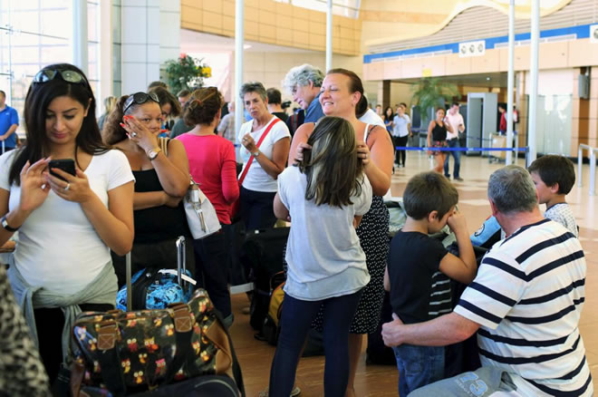 Passengers, including British nationals, of an easyJet flight to Britain, wait after their flight got cancelled, at the airport of the Red Sea resort of Sharm el-Sheikh November 6, 2015. Airline easyJet said on Friday Egyptian authorities had suspended British airlines from flying into the Sharm al-Sheikh, meaning that many of the flights planned to repatriate British tourists from the resort would no longer be able to operate. REUTERS/Asmaa Waguih