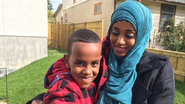 Sahra Ali Ahmed, her six-year-old son, Amin, and three other refugee claimants had walked for seven hours to reach the Canada-U.S. border crossing at Emerson, Man., over the weekend. (Karen Pauls/CBC)