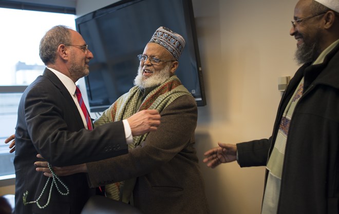 Imam Sheikh Sa’ad Musse Roble, with the World Peace Organization, greeted U.S. Attorney Andrew Luger alongside Imam Ahmed Burale before a community meeting in 2015. Luger is leading a Muslim outreach initiative in hopes of thwarting terrorist groups from recruiting vulnerable, homegrown kids, and he has advocated for funding. AARON LAVINSKY
