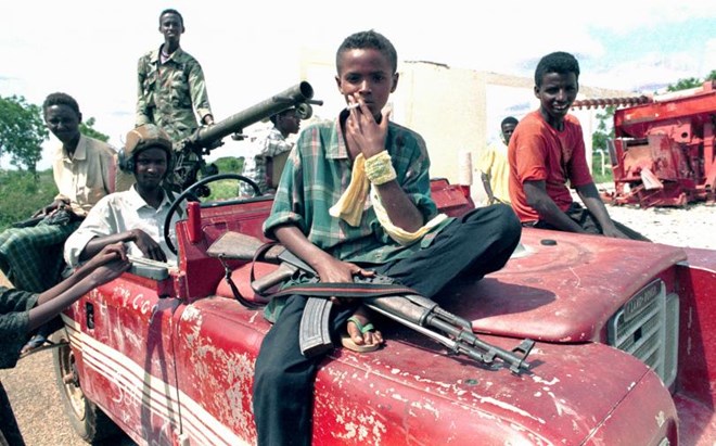 A young Somali smokes and holds a weapon as he and his friends sit on a car in Baidoa, Somalia, Dec. 14, 1992.
PHOTO: REUTERS/YANNIS BEHRAKIS YB/CMC