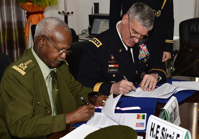 Gen. Samora Yunis, Chief of the General Staff of Ethiopian National Defence Force (L) and  Gen. David Rodriguez, U.S. Africa Command commander (R), Signing the summary of conclusions after a bilateral defence committee meeting in Addis Ababa, Ethiopia on March 30, 2016 [Photo by Tech. Sgt. Dan DeCook/ US Air force]