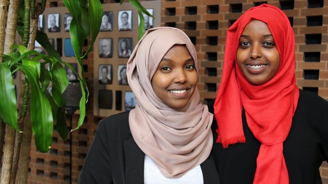 Khadra Fiqi, left, and Hodo Ibrahim pose for a picture Friday. Fiqi says she sees Donald Trump's arrival in Minnesota as a symbol of a troubled America. Laura Yuen | MPR News