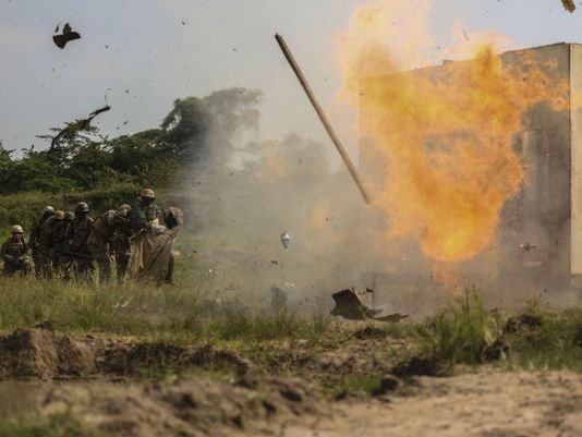 A Ugandan soldier detonates an "oval charge" on desired entry point during a breaching exercise at Camp Singo. The Marines and Ugandans improved breaching capabilities as they prepare for a deployment to Somalia to fight the al-Shabaab terror group.
(Photo: Cpl. Olivia McDonald/Marine Corps)