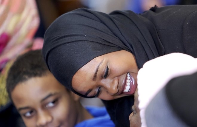 Zahra Abu speaks with family members Friday before her swearing-in ceremony at Portland City Hall. Five new members joined the Portland Police Department, including Abu, Maine’s first Somali officer. Gabe Souza/Staff Photographer