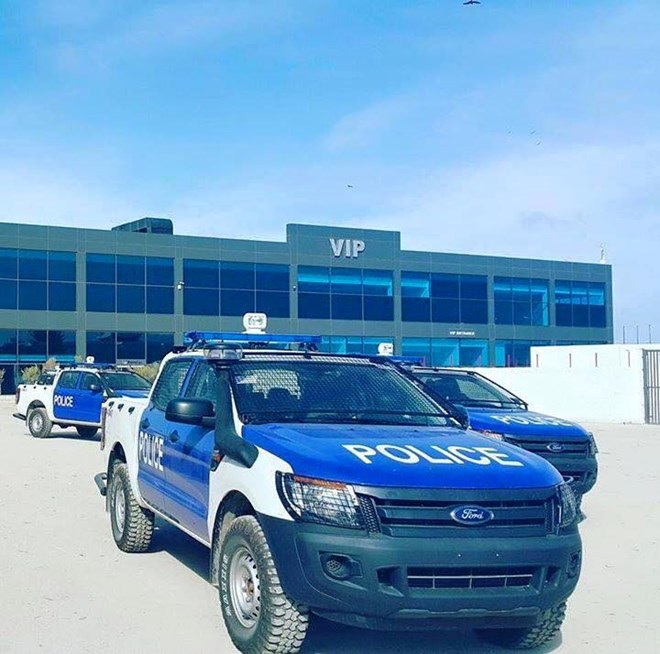 (Police vehicles parked outside of the new built terminal at Adan Adde International Airport, constructed by a Turkish firm in 2013.)