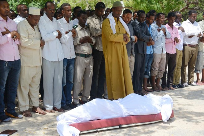 Relatives and fellow journalists pray over the body of Somali journalist Yusuf Keynan, on June 21, 2014, during his funeral. Keynan died in Mogadishu after a bomb believed to have been attached to his car was remotely detonated.
© 2014 Getty Images/Mohamed Abdiwahab