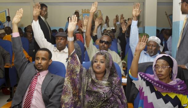 FILE - Somalia lawmakers raise their hands during a confidence vote on Prime Minister Abdiweli Sheikh Ahmed, at the Parliament Building in Mogadishu, Somalia, Dec. 6, 2014.