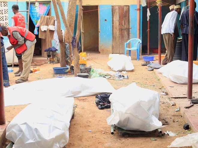 A file photo of Kenya Red Cross workers stand near dead bodies after an attack by al Shabaab militants in Mandera on October 6,2016 Photo/File