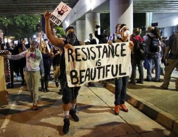 Protesters walk in the streets downtown during another night of protests over the police shooting of Keith Scott in Charlotte, North Carolina, U.S. September 22, 2016. REUTERS/Mike Blake
