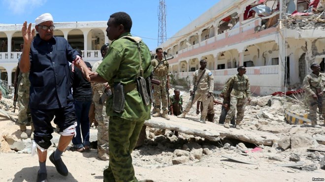 Security forces assist Abdalla Boss, a Somali parliamentarian wounded in a car bombing near the president's palace in Mogadishu, Aug. 30, 2016. Al-Shabab asserted responsibility. The U.S. military says it conducted airstrikes Monday against al-Shabab militants.