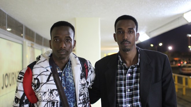 Abdi Nor (L) and his older brother Hassan Iftin (R) wish each other well at Nairobi Airport,  Aug. 11, 2014. A few minutes after this photo was taken, Abdi boarded a flight to start a new life as a green card holder in Boston. The brothers have not been able to meet since.