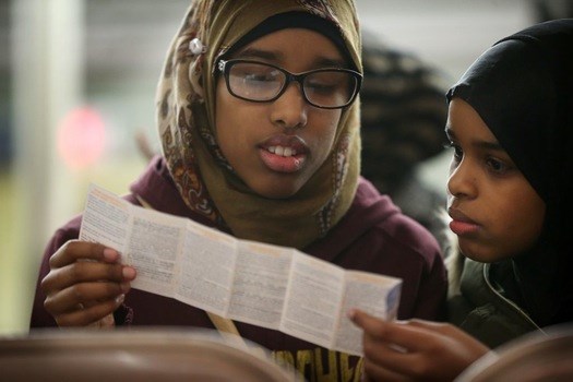 Sumaya Hanafi, left, and her sister Amina Hanafi read over a pamphlet "know your rights and responsibilities as an American Muslim" during a information meeting at CAIR-MN on Tuesday in Minneapolis.
