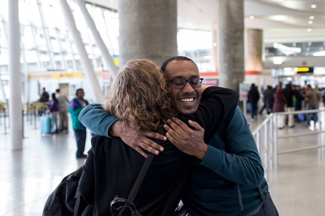 Dr. Kamal Fadlalla was greeted at Terminal 4 of Kennedy International Airport after being stranded in his native Sudan, where he had been visiting his mother.