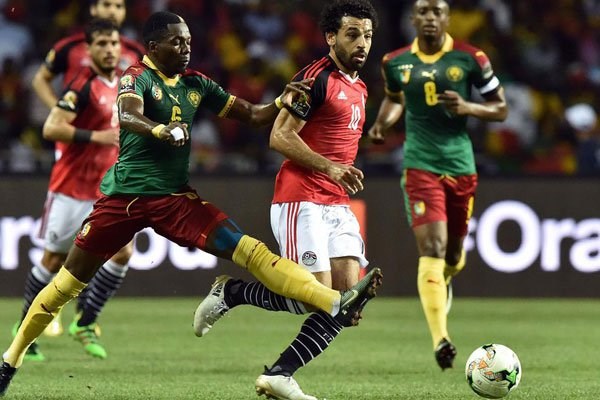 Cameroon's defender Ambroise Oyongo (left) vies for the ball against Egypt's forward Mohamed Salah during the 2017 Africa Cup of Nations final football match between Egypt and Cameroon at the Stade de l'Amitie Sino-Gabonaise in Libreville on February 5, 2017. Cameroon has won the Cup. PHOTO | AFP
