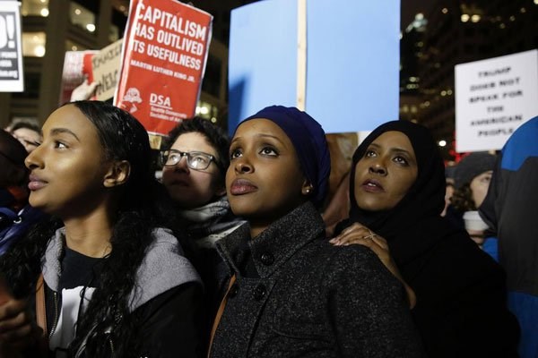Ayla Ali and her Somali refugee family members, cousin Ryan Adem and aunt Maryan Farah, listen to speakers at a rally for immigrants and refugees in Seattle, Washington on January 29, 2017. PHOTO | JASON REDMOND | AFP