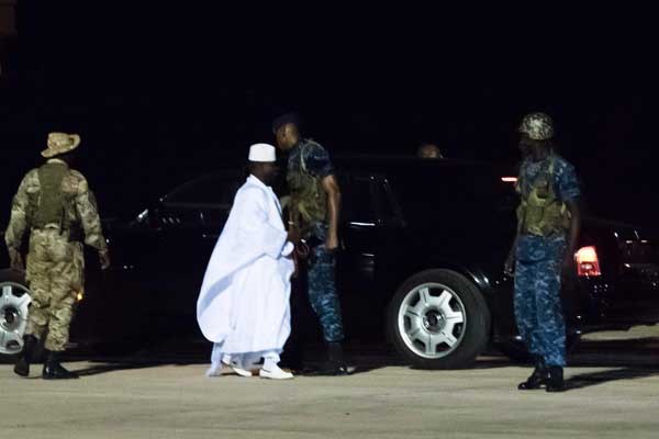 Former president Yaya Jammeh (centre), the Gambia's leader for 22 years, walks towards the plane as he leaves the country on 21 January 2017 in Banjul airport. AFP PHOTO