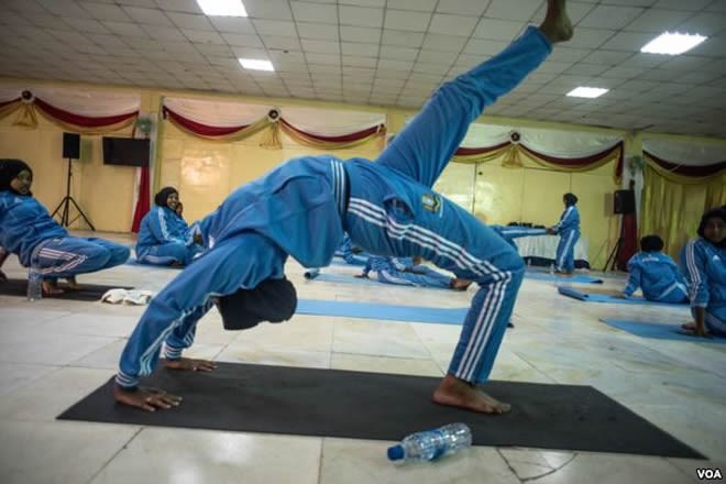 A woman practices a pose during a mind-body wellness program for survivors of trauma in Mogadishu, Somalia, Jan. 16, 2017. (J. Patinkin/VOA)