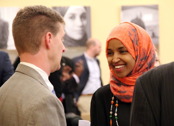 Shep Harris, left, a lobbyist hired by the Coalition of Somali American Leaders, speaks with Rep. Ilhan Omar in St. Paul, Minn., on Jan. 22, 2016. Laura Yuen | MPR News