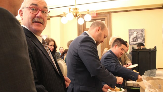 State lawmakers and staff, including Sen. David Tomassoni, second from left, line up for sambusas at the Capitol on Jan. 22, 2017. Laura Yuen | MPR News