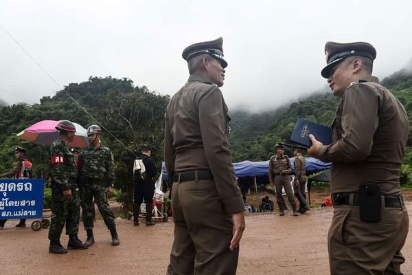 Thai police and soldiers guard a road leading to the Tham Luang cave area as operations continue for the 12 boys and their coach trapped at the cave in Khun Nam Nang Non Forest Park in the Mae Sai district of Chiang Rai province on July 8, 2018. PHOTO | LILLIAN SUWANRUMPHA | PHOTO
