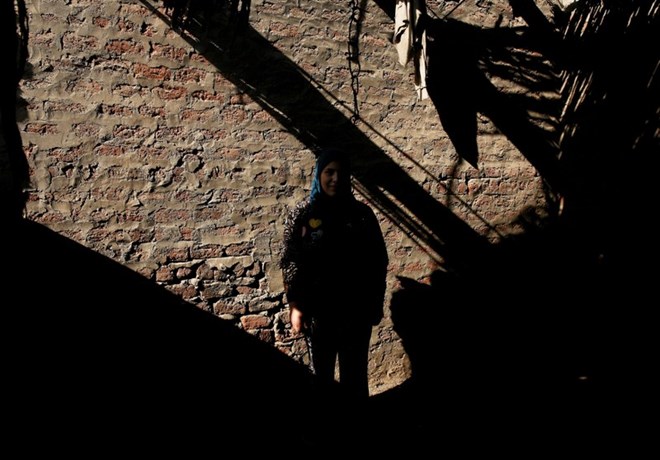 Esraa Salah, 15, poses for a photograph outside her home in Alwasata village of Assiut Governorate, south of Cairo, Egypt, February 8, 2018. Picture taken February 8, 2018. REUTERS/Hayam Adel