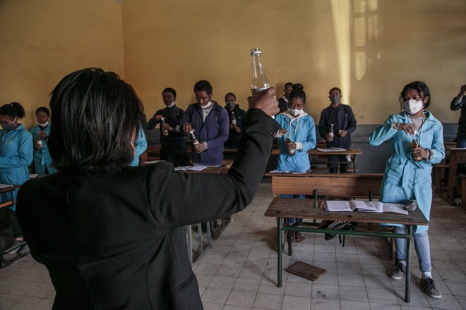 Students at a high school in Madagascar, preparing to drink bottles of Covid Organics, an herbal tea touted by the country’s president, Andry Rajoelina, as a powerful remedy for the coronavirus.Credit...Rijasolo/Agence France-Presse — Getty Images