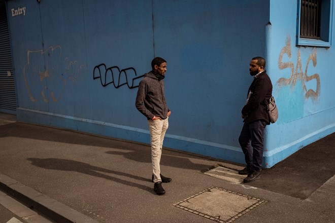 Community health worker Ahmed Dini and colleague Nor Shanino discuss a proposed call centre to help with the mental health and concerns of residents in Flemington and North Melbourne housing commission flats. Photograph: Christopher Hopkins/The Guardian