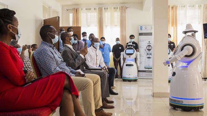 A robot introduces itself to patients in Kigali, Rwanda. The robots, used in Rwanda's treatment centers, can screen people for COVID-19 and deliver food and medication, among other tasks. The robots were donated by the United Nations Development Program and the Rwanda Ministry of ICT and Innovation.
Cyril Ndegeya/Xinhua News Agency/Getty Images