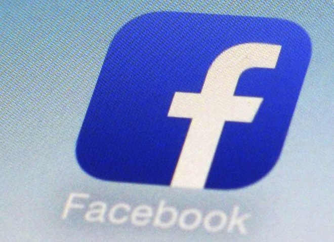 This Feb. 19, 2014, file photo, shows a Facebook app icon on a smartphone in New York. The Australian government said on Friday, July 31, 2020 it plans to give Google and Facebook three months to negotiate with Australian media businesses fair pay for news content. (AP Photo/Patrick Sison, File)