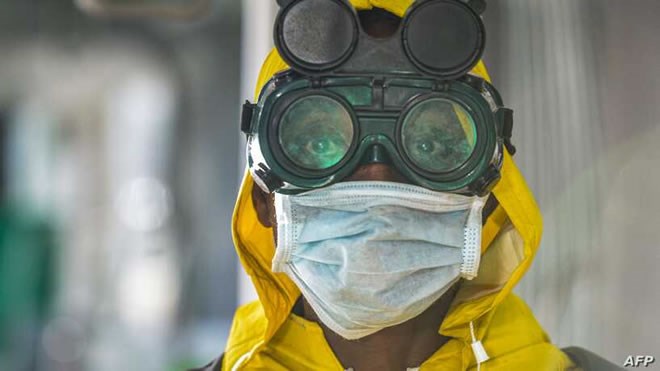 A cleaning staff wears protective gear to disinfect a metro carriage against the spreading of the COVID-19 coronavirus in Addis Ababa, Ethiopia, March 20, 2020.
