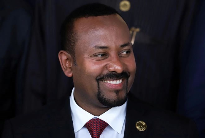 FILE PHOTO: Ethiopian Prime Minister Abiy Ahmed smiles during an African Union (AU) summit meeting in Addis Ababa, Ethiopia, February 9, 2020. REUTERS/Tiksa Negeri - RC22XE930YBN/File Photo