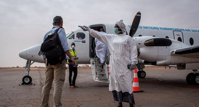 An airport staffer at Mopti Airport in Mali supported by the World Food Program, which on Friday was awarded the Nobel Peace Prize, and Latter-day Saints Charities takes temperature readings of passengers. The airport provide lifesaving transportation services to humanitarian aid workers. The Church of Jesus Christ of Latter-day Saints