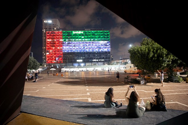 The flag of the United Arab Emirates projected on city hall in Tel Aviv after the announcement of the establishment of diplomatic ties between Israel and the U.A.E.Credit...Oded Balilty/Associated Press