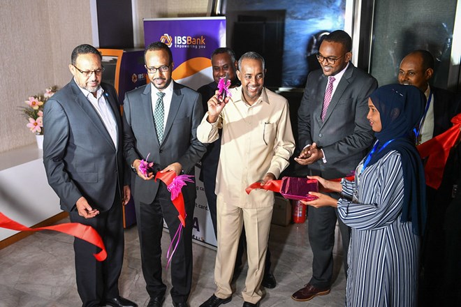 The Prime Minister of the Federal Republic of Somalia, Mohamed Hussein Roble, cuts the ribbon to officiate the launch of the VISA card service by the International Bank of Somalia (IBS) in Mogadishu, Somalia. The service launched on Wednesday 7 July 2021, marks a significant milestone for Somalia’s re-emerging financial sector. AMISOM photo / Fardowsa Hussein