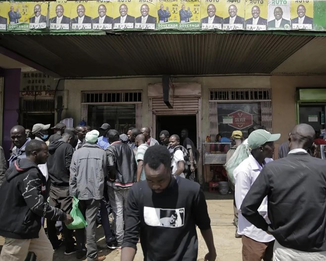 People gather in Eldoret, Kenya, Wednesday Aug. 10, 2022. Kenyans are waiting for results in the presidential elections that saw opposition leader Raila Odinga facing Deputy President William Rutoto in their bid to succeed President Uhuru Kenyatta who stayed in power for a decade.  BRIAN INGANGA / AP PHOTO
