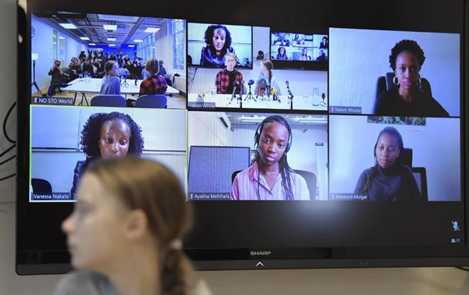 Climate activist Greta Thunberg, looks round at a video link during a press conference with climate activists and experts from Africa in Stockholm, Sweden, Friday Jan. 31, 2020. Participating on the video link in the background are: top right, Makenna Muigai of Kenya, and from bottom left, Ndoni Mcunu from South Africa, Vanessa Nakate from Uganda, and Ayakha Melithafa, also from South Africa. Ugandan climate activist Vanessa Nakate and peers from other African nations on Friday made an urgent appeal for the world to pay more attention to the continent that stands to suffer the most from global warming despite contributing to it the least. (Pontus Lundahl/TT via AP) (Associated Press)