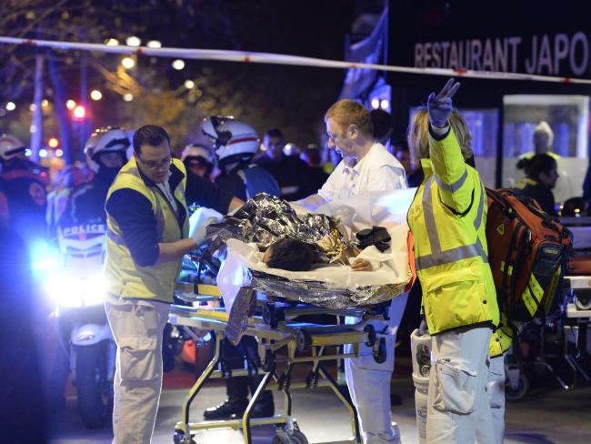 Rescuers evacuate an injured person near the Bataclan concert hall. AFP: Miguel Medina.Source:AFP