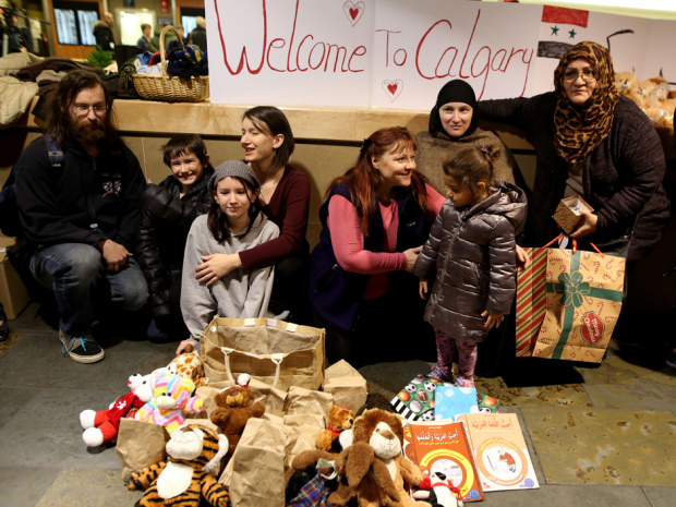 Supporters and family members await the first group of Syrian refugees to arrive at the Calgary International Airport on November 23, 2015.