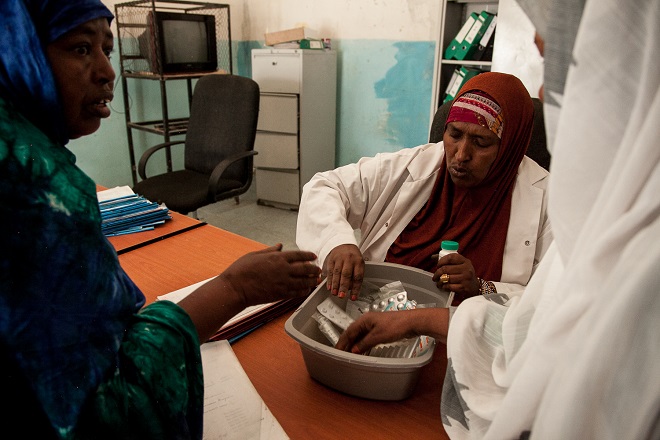 Maryam Hassan Dahir, nurse at the Hargeisa Group Hospital mental health ward, hands out medication to patients. There are two qualified psychiatric doctors in Somaliland for an estimated population of 3.5 million. [Zoe Flood/Al Jazeera]