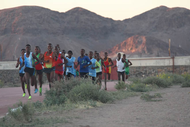 Kadra (in dark blue) runs a 3k with men.