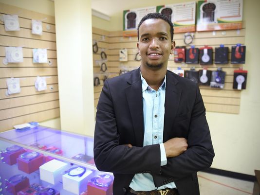 Mohamed Jama Mohamud stands Thursday, Aug. 13, in his small store in St. Cloud. Mohamud programs devices to receive television channels from throughout the world and installs those devices in customer's homes.