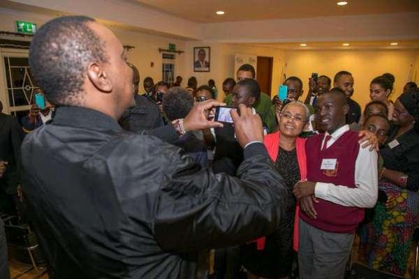President Uhuru Kenyatta takes pictures of students under the Pupils Reward Scheme mentorship programme, who were hosted at State House, Nairobi, on Thursday night.