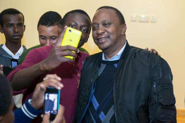 President Uhuru Kenyatta takes a selfie with some of the students under the Pupils Reward Scheme mentorship programme, who were hosted at State House, Nairobi, on Thursday night.