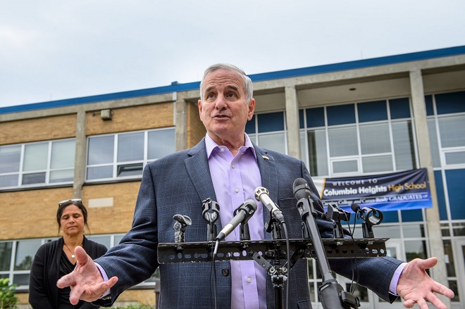 Gov. Mark Dayton spoke to the media after with students at Columbia Heights High School on Friday. On the left is Education Commissioner Brenda Cassellius.