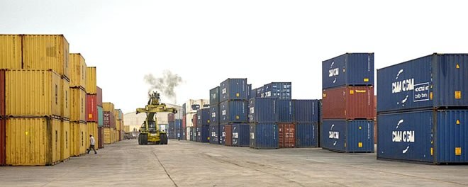 A container lift truck drives among containers at Mogadishu’s shipping port. Mogadishu’s port, having recently modernized to facilitate the shipping of containers, has made it much easier for the country to ship larger quantities of goods in and out of its port facilities. AMISOM PHOTO - TOBIN JONES