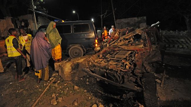 This image taken on September 21, 2015, in the Somali capital, Mogadishu, shows the wreckage of a car after a bomber attacked the presidential compound. (AFP Photo)